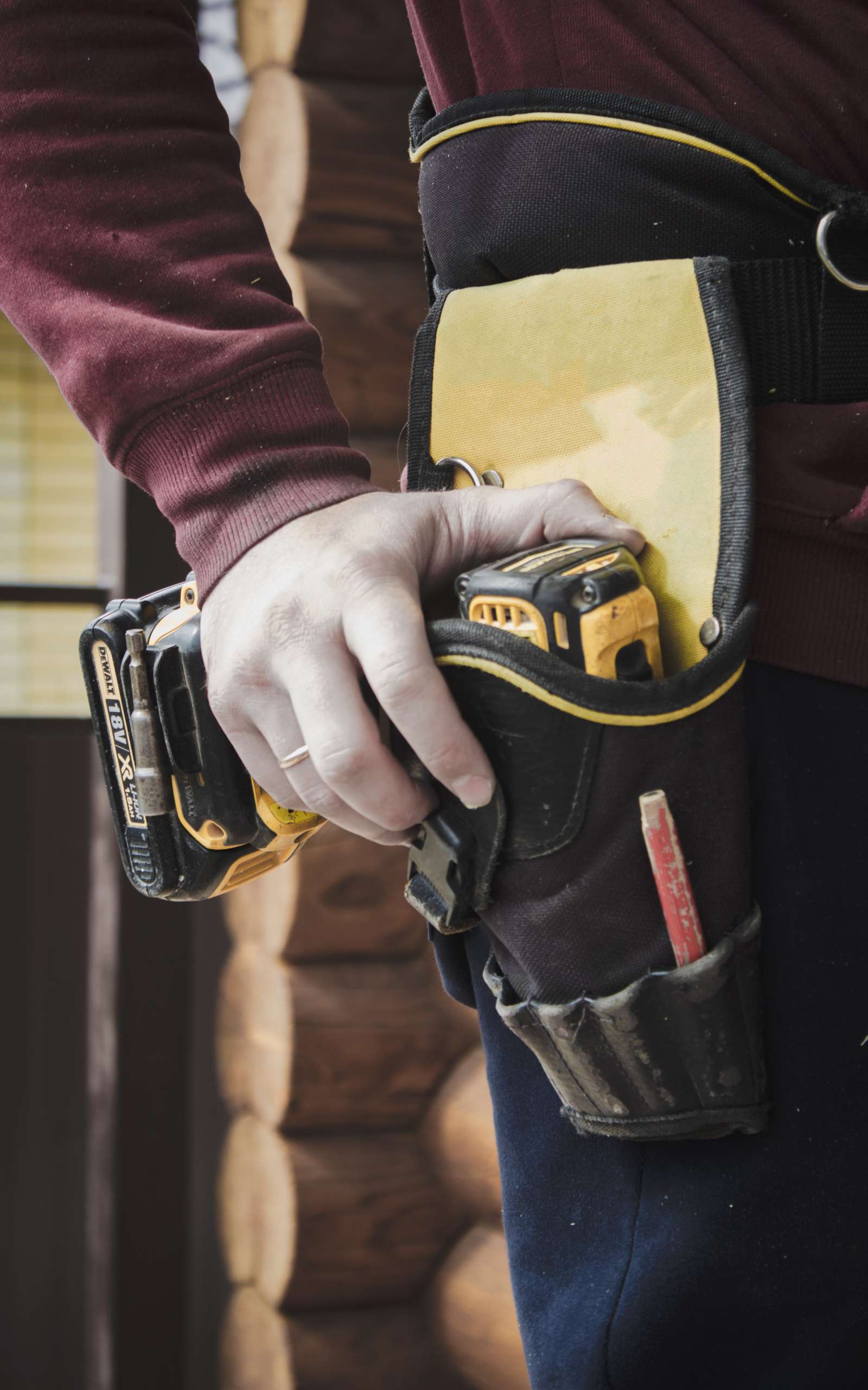 worker holding a drill in its holster