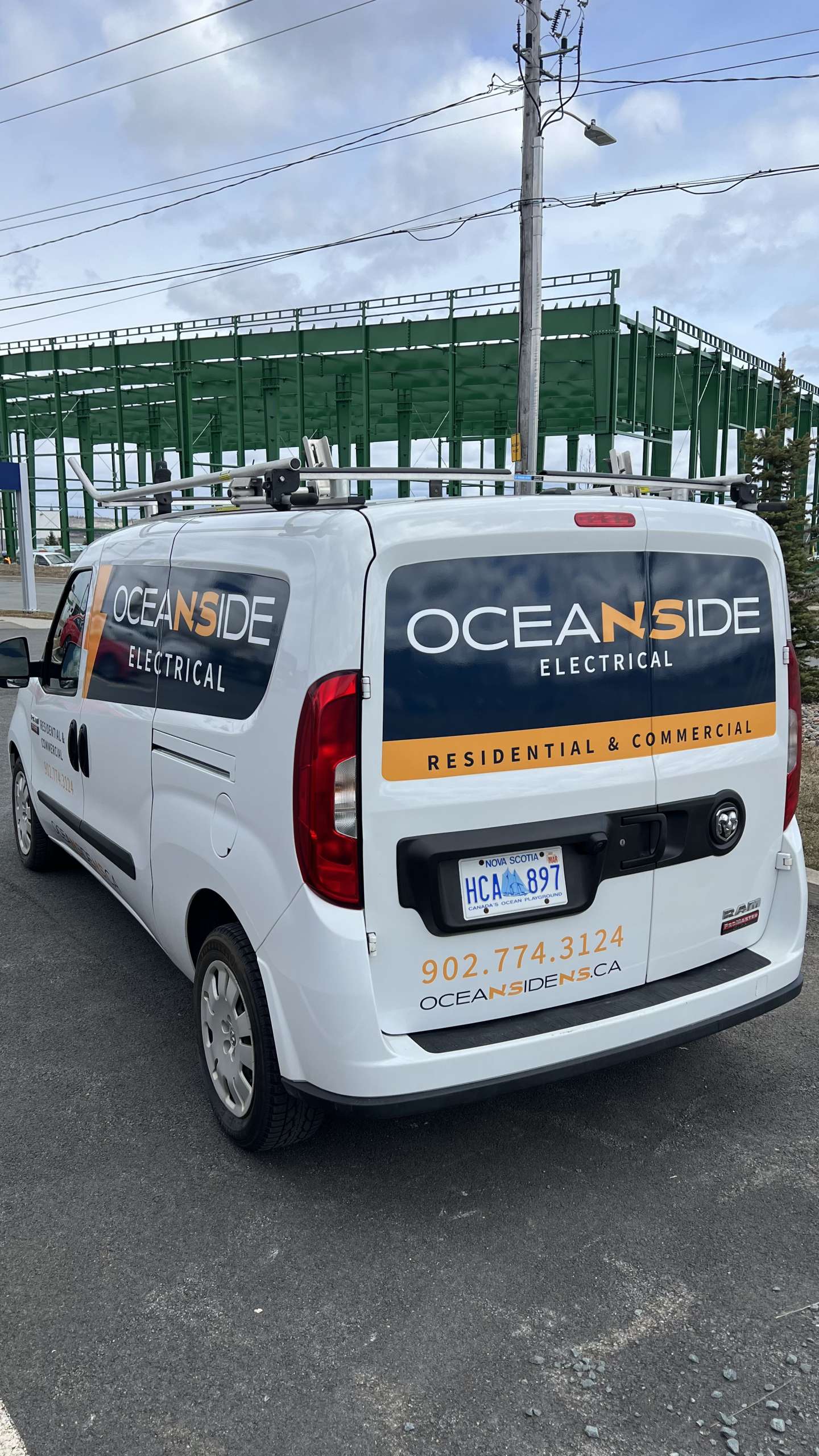Oceanside Electrical work van on construction site.